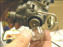 glass fuel filter on the bottom of the carburetor